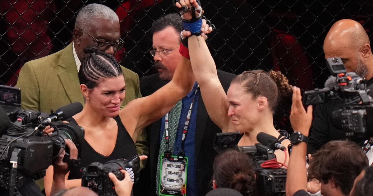 Ronda Rousey defeats Gina Carano in 17 seconds at a high-profile MMA event, retires